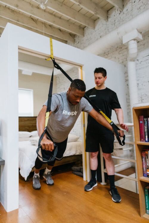 Personal trainer with client in his home