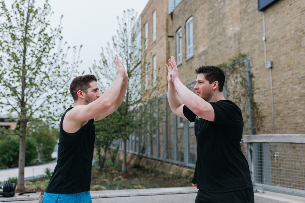 Personal Trainer High Fives Client